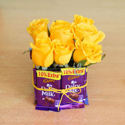 9 Yellow Roses+8 Dairy milk in a square vase