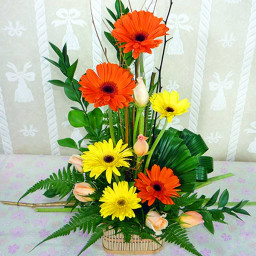 Pink roses with orange and yellow Geraberas in a Flower Basket