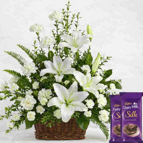 Basket of Happiness: A Gift Combo of 20 White Carnations, 4 White Lily with Basket Arrangement, and 4 Dairy Milk Silk