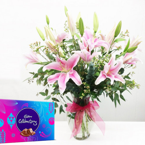7 Pink lilies in vase arrangement with cadbury celebration 