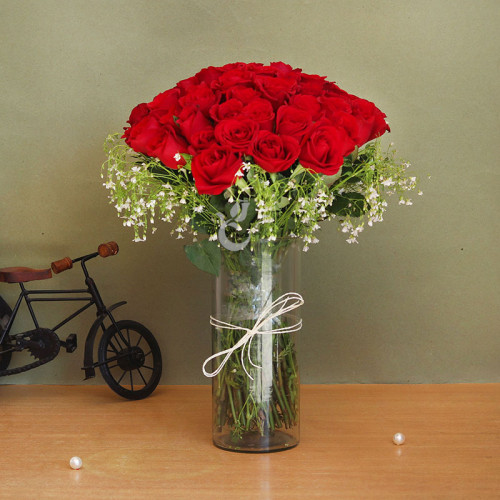 50 red roses in alarge glass vase